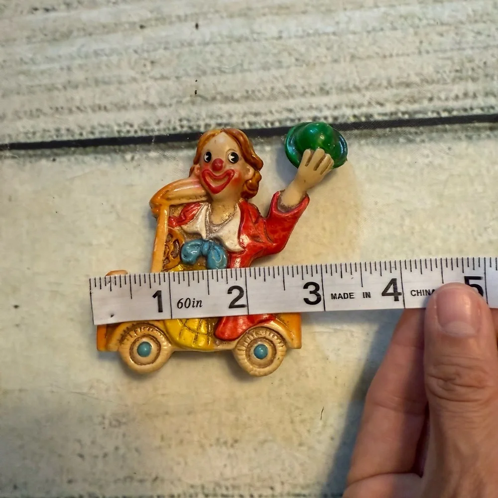 Vintage clown figurine riding in a car. Made in Japan.
